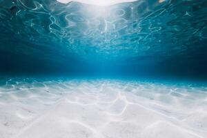 Tropical blue ocean with sandy bottom in Bahamas island. Underwater background photo
