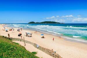 January 8, 2022. Florianopolis, Brazil. Holiday beach with people and blue ocean in Brazil. Morro das Pedras beach in Florianopolis photo