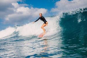 Woman surfer rides on perfect wave on a sunny day and the beauty of surfing in ocean. photo